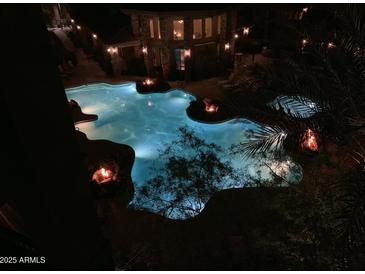 Inviting community pool featuring rockwork accents and cozy fire pits for evening relaxation at 5450 E Deer Valley Dr # 4018, Phoenix, AZ 85054