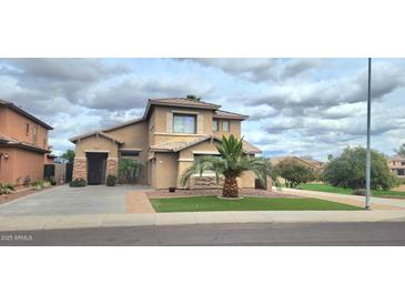 Charming two-story home boasts a well-manicured lawn, appealing desert landscaping, and an attached two-car garage at 15342 W Tasha Dr, Surprise, AZ 85374