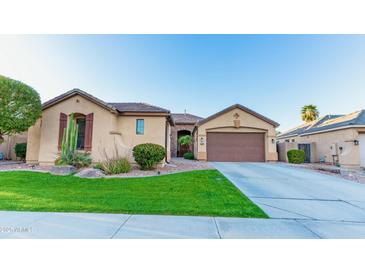 Charming single-story home with well-maintained landscaping and a two-car garage at 15430 W Sells Dr, Goodyear, AZ 85395