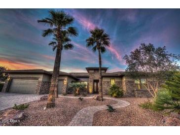 Stunning single story home with desert landscaping and a three car garage at 19644 N Majestic Vista Ct, Surprise, AZ 85387