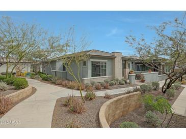 Charming single-story home featuring stone accents, desert landscaping, and a private walkway at 20721 W Fern Dr, Buckeye, AZ 85396