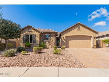 Charming single-story home featuring a stone facade, low-maintenance landscaping, and a two-car garage at 520 S 196Th Dr, Buckeye, AZ 85326