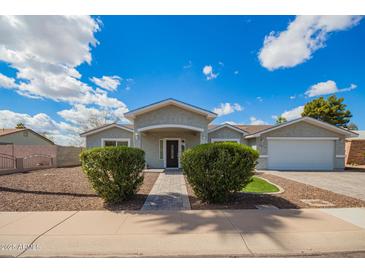 Charming single-story home with a well-manicured yard and inviting entrance, perfect for suburban living at 13616 N 41 Pl, Phoenix, AZ 85032