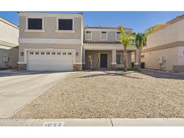 Charming two-story home featuring a two-car garage and drought-tolerant landscaping at 1677 E Heather Dr, San Tan Valley, AZ 85140