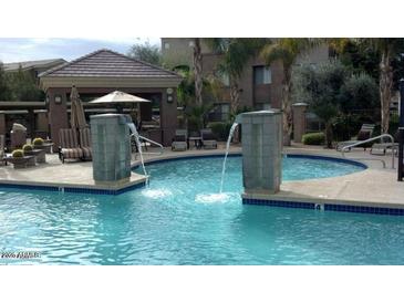 A community pool with water features and nearby seating area at 18416 N Cave Creek Rd # 1053, Phoenix, AZ 85032