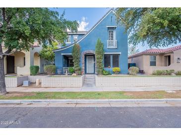 Charming blue two-story home with well-maintained landscaping and stone front door archway at 3432 E Jasper Dr, Gilbert, AZ 85296