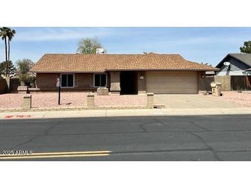 Charming single-story home with a well-maintained yard and attached two-car garage at 10250 N 65Th N Ave, Glendale, AZ 85302