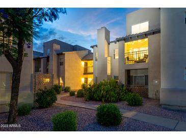 Charming condo exterior with landscaped grounds and cozy balcony lighting at 14145 N 92Nd St # 2077, Scottsdale, AZ 85260