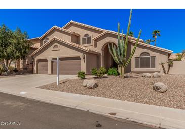 Beautiful two-story home featuring a tile roof, desert landscaping, and a three-car garage at 2108 E Tecoma Rd, Phoenix, AZ 85048