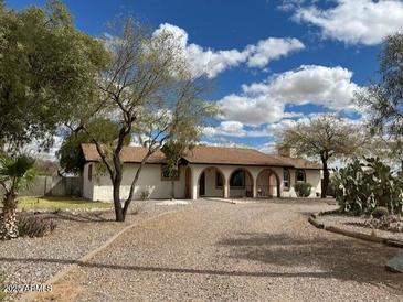Charming ranch-style home with a gravel front yard, mature trees, and a covered porch in a serene setting at 2151 S Calle Del Marcos --, Casa Grande, AZ 85194