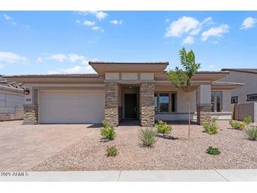 Charming single-story home with stone accents, low maintenance desert landscaping, and a two car garage at 21539 S 191St Pl, Queen Creek, AZ 85140