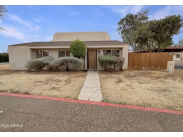 Charming single-story home with a quaint entrance and mature landscaping at 2155 W Farmdale Ave # 24, Mesa, AZ 85202