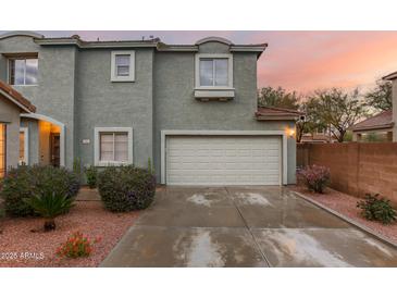 Charming two-story home with a two-car garage, desert landscaping, and a beautiful sunrise at 21860 N 41St St, Phoenix, AZ 85050