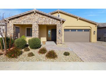 Inviting single-story home featuring a stone facade and a well-maintained desert landscape in the front yard at 24738 N 175Th Ave, Surprise, AZ 85387