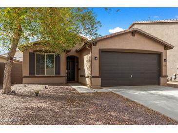 Charming single-story home featuring a low-maintenance front yard and a two-car garage at 35730 N Pommel Pl, San Tan Valley, AZ 85144