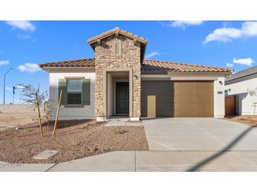 Charming home featuring a stone accent wall, a brown garage door, and desert landscaping at 3746 S 234Th Ln, Buckeye, AZ 85326