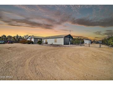 Charming single-story home with neutral paint, desert landscaping, and a gated entrance at 404 W Galvin St, Phoenix, AZ 85086