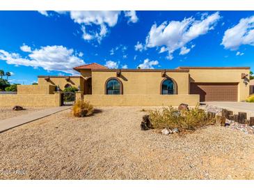 Beautiful single-story home showcasing a well-kept yard, brown trim, and attached garage at 7656 W Wagoner Rd, Glendale, AZ 85308