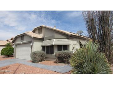 Charming single-story home with desert landscaping, light stucco, and a two-car garage at 20479 N 105Th Ave, Peoria, AZ 85382