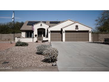 Charming single-story home featuring a well-manicured desert landscape and two-car garage at 3721 N Brindley Ave, Litchfield Park, AZ 85340