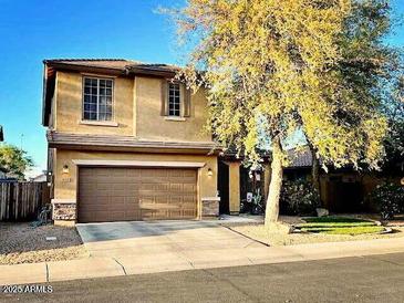 Charming two-story home featuring a spacious two-car garage and a well-maintained front yard with mature trees at 4134 E Bellerive Dr, Chandler, AZ 85249