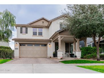 Charming two-story home featuring a covered front porch and a neutral color palette at 4381 E Rawhide St, Gilbert, AZ 85296