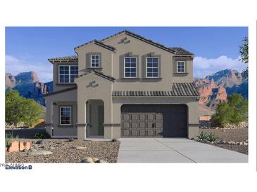 Charming two-story home featuring a neutral gray facade and a two-car garage, set against a picturesque mountain backdrop at 7417 W Buckhorn Trl, Peoria, AZ 85383