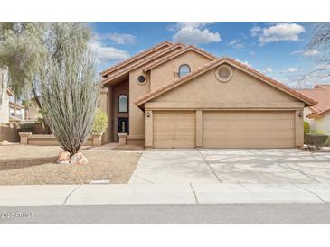 Charming two-story home featuring a three-car garage and drought-tolerant landscaping at 13383 N 101St Way, Scottsdale, AZ 85260