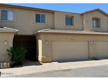 Inviting two-story townhouse with attached garage and neutral stucco exterior at 15655 N 29Th St, Phoenix, AZ 85032
