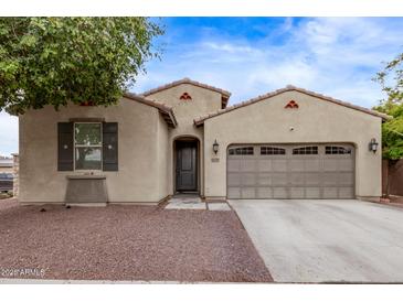 Charming single-story home with desert landscaping, private entry, and a two car garage at 16268 W Cortez St, Surprise, AZ 85379