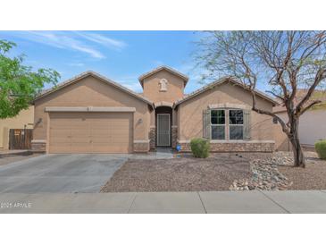 Single-story home with desert landscaping, a two-car garage, and a covered entryway at 2146 W Ian Dr, Phoenix, AZ 85041