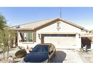 Charming single-Gathering home with a well-manicured front yard and a two-car garage, reflecting suburban appeal at 7134 S 254Th Ln, Buckeye, AZ 85326