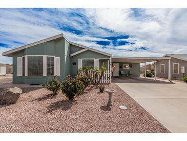 Charming single-story home with an attached carport and colorful desert landscaping at 8500 E Southern Ave # 379, Mesa, AZ 85209