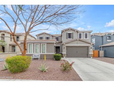 Charming two-story home featuring neutral color scheme, two-car garage, and beautiful landscaping at 3555 E Gary Way, Gilbert, AZ 85234
