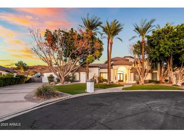 Stunning home with lush landscaping, mature trees, and manicured lawn at 3630 E Coconino Ct, Phoenix, AZ 85044