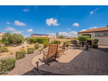 Charming backyard patio with seating and landscaping, ideal for relaxing outdoors and enjoying the views at 37036 N Stoneware Dr, Queen Creek, AZ 85140