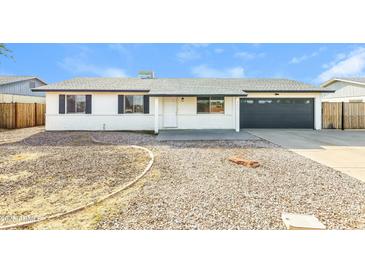 Charming single-story home featuring a well-maintained gravel yard, attached garage, and a cozy front porch at 4207 W Poinsettia Dr, Phoenix, AZ 85029
