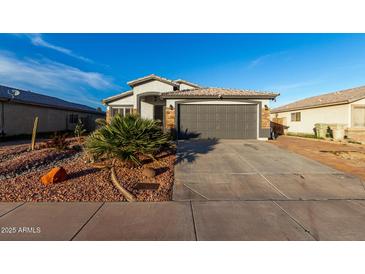 Charming single-story home showcasing a well-kept front yard and two car garage at 5361 N 77Th Ln, Glendale, AZ 85303