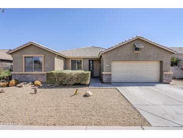 Inviting single-story home featuring a low-maintenance desert landscape and attached two-car garage at 6615 S 25Th Dr, Phoenix, AZ 85041