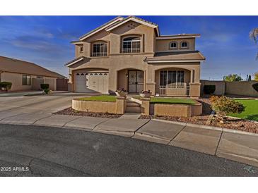 Inviting two-story home with landscaped front yard and charming architectural details and covered porch entrance at 7628 W Donald Dr, Peoria, AZ 85383