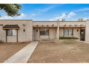 Charming single-story home featuring a stucco exterior and a welcoming front walkway at 914 N Cherry --, Mesa, AZ 85201