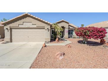 Charming single-story home featuring low-maintenance desert landscaping and a two-car garage at 10318 W Luke Ave, Glendale, AZ 85307