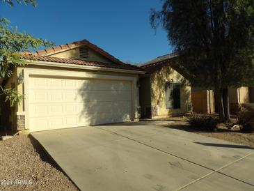 Charming single-story home with a two-car garage and a well-maintained front yard at 25176 W Cranston Ln, Buckeye, AZ 85326