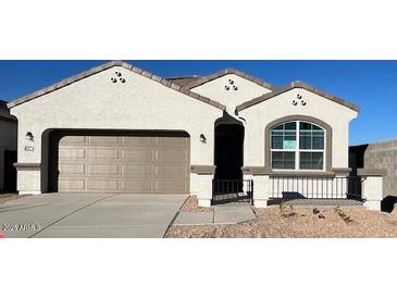 Single-story home featuring a neutral color scheme, complemented by a convenient two-car garage at 25436 W Graham Trl, Buckeye, AZ 85326