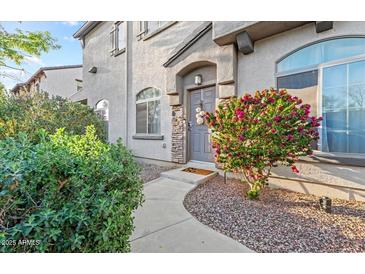 Charming townhome showcasing a walkway to the front door and landscaped yard with flowering shrub at 2727 N Price Rd # 26, Chandler, AZ 85224