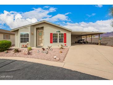 Charming single-story home features a covered carport and well-manicured desert landscaping in the front yard at 3301 S Goldfield Rd # 2105, Apache Junction, AZ 85119