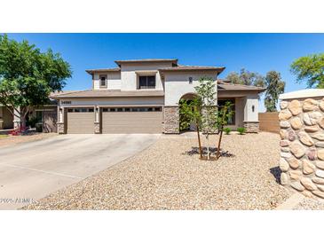 Stunning two-story home with a three-car garage and desert landscaping at 34990 N Spur Cir, San Tan Valley, AZ 85144