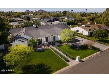 Aerial view of a charming single-story home with manicured lawn and mature trees in a desirable neighborhood at 6455 E Calle Del Media --, Scottsdale, AZ 85251