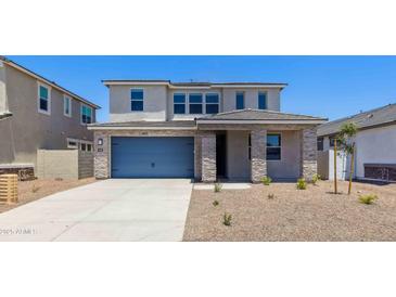 Charming two-story home featuring stone accents, neutral colors, and a well-maintained front yard at 7436 W Buckhorn Trl, Peoria, AZ 85383