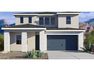 Beautiful two-story home with a gray garage door, desert landscaping, and mountain views at 7436 W Buckhorn Trl, Peoria, AZ 85383